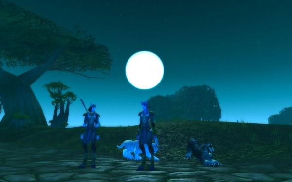 Kriysia, Daari, and their cats beneath a full moon